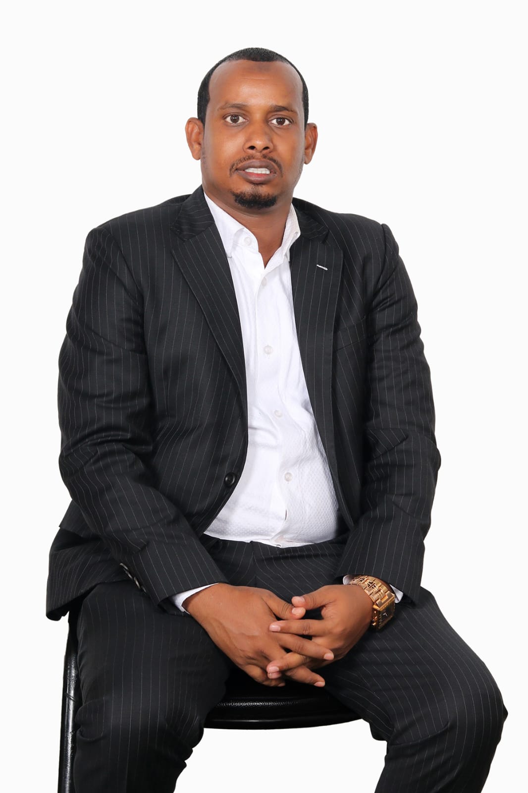 CEO — confident seated pose, hands clasped